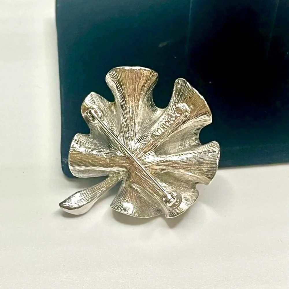 Two Elegant Silver tone Sarah Coventry brooches.